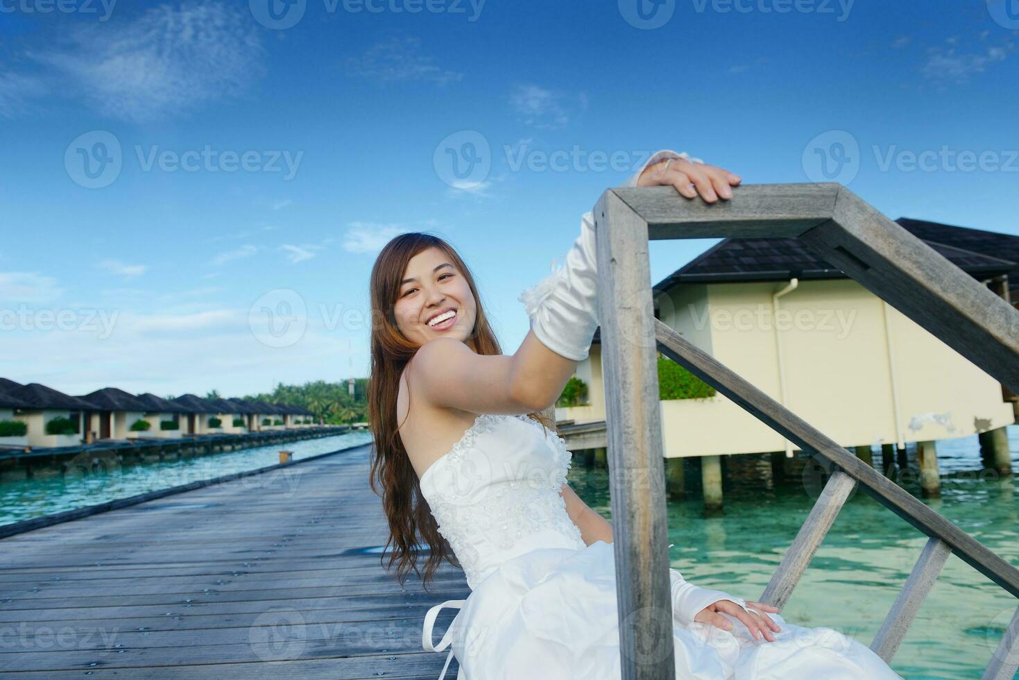 asian bride on beach photo