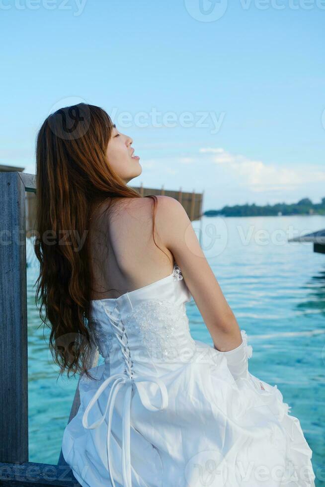 asian bride on beach photo