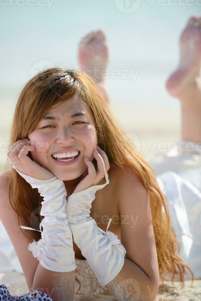 asian bride on beach photo