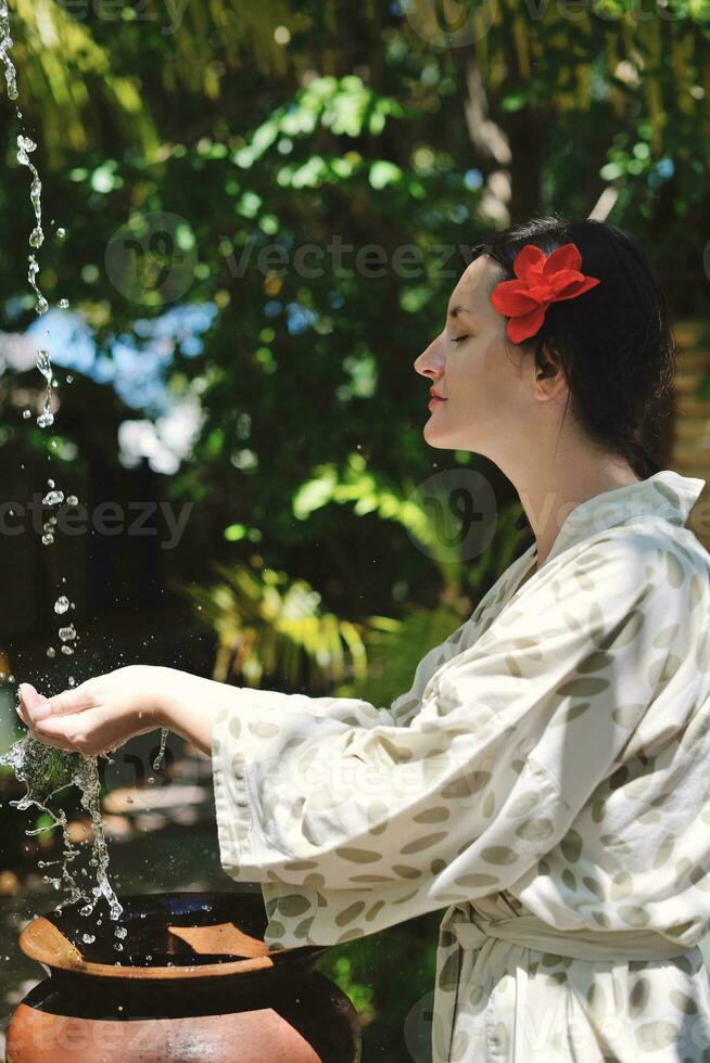 splashing fresh water on woman hands photo