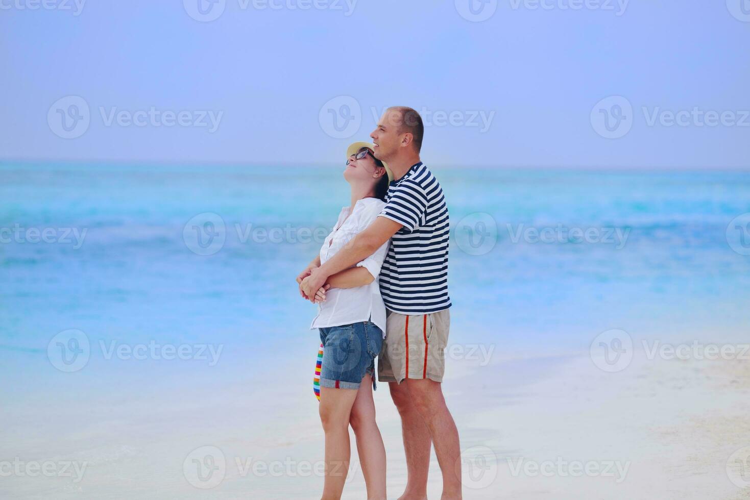 happy young couple have fun on beach photo