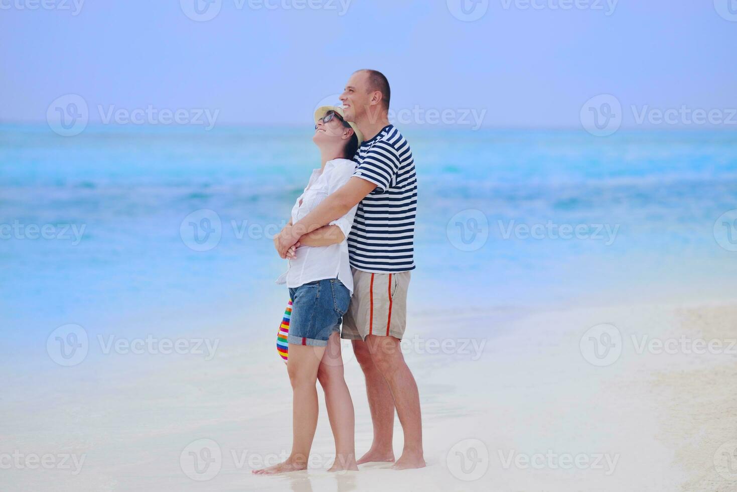 happy young couple have fun on beach photo