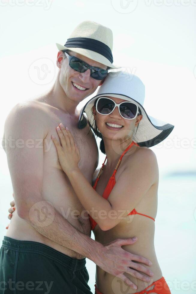 happy young couple have fun on beach photo