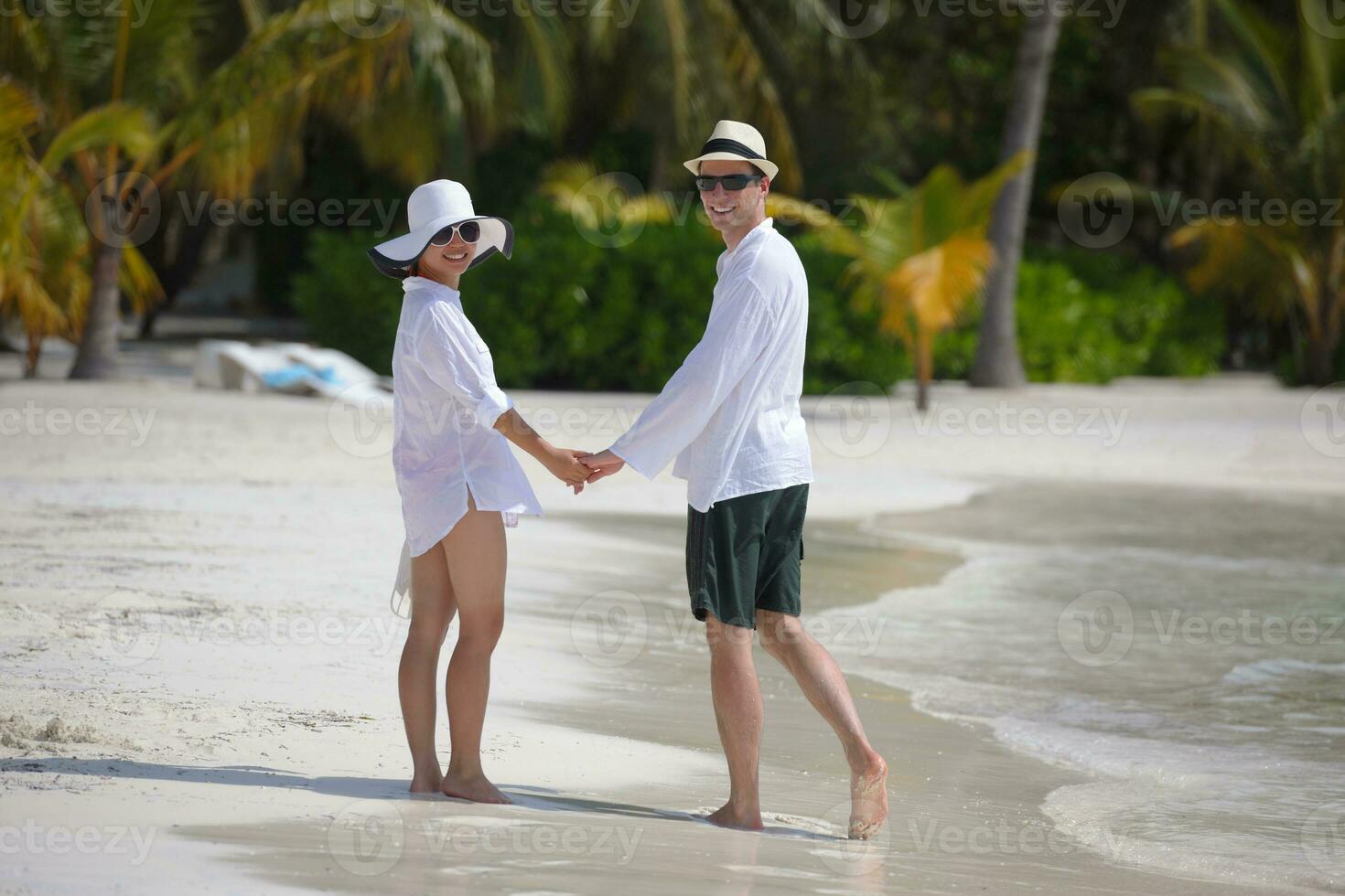 happy young couple have fun on beach photo
