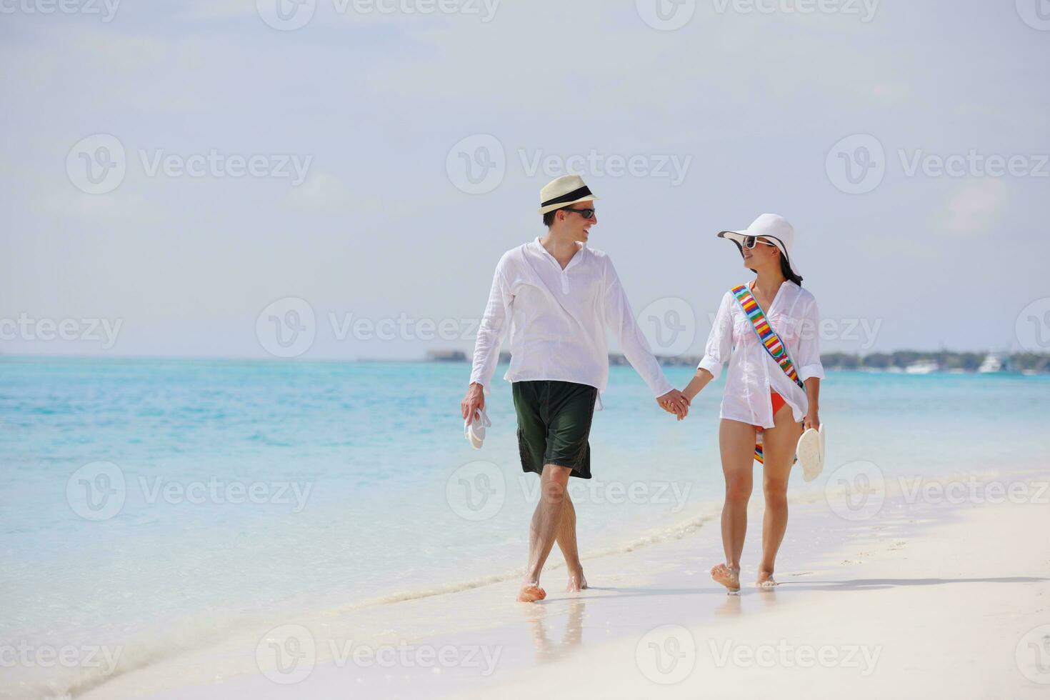 happy young couple have fun on beach photo