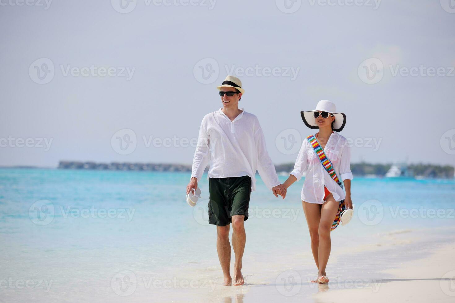 happy young couple have fun on beach photo