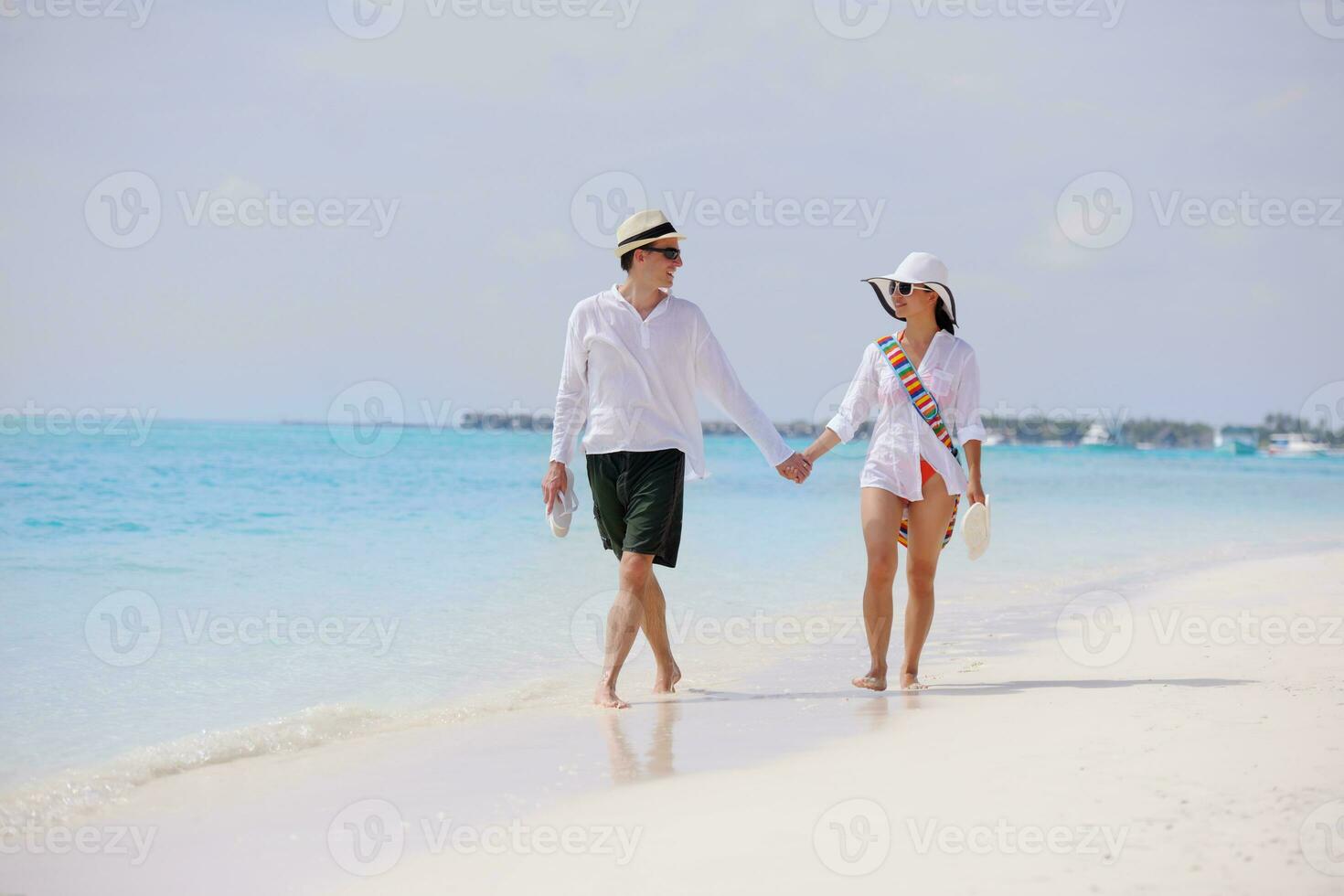 happy young couple have fun on beach photo