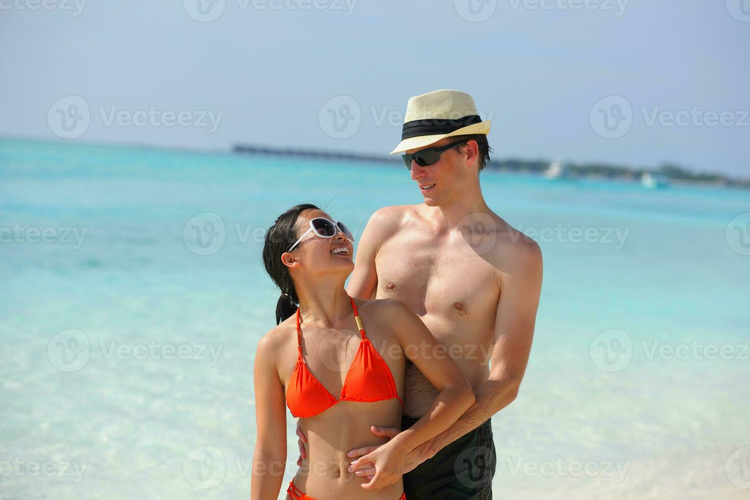 happy young couple have fun on beach photo