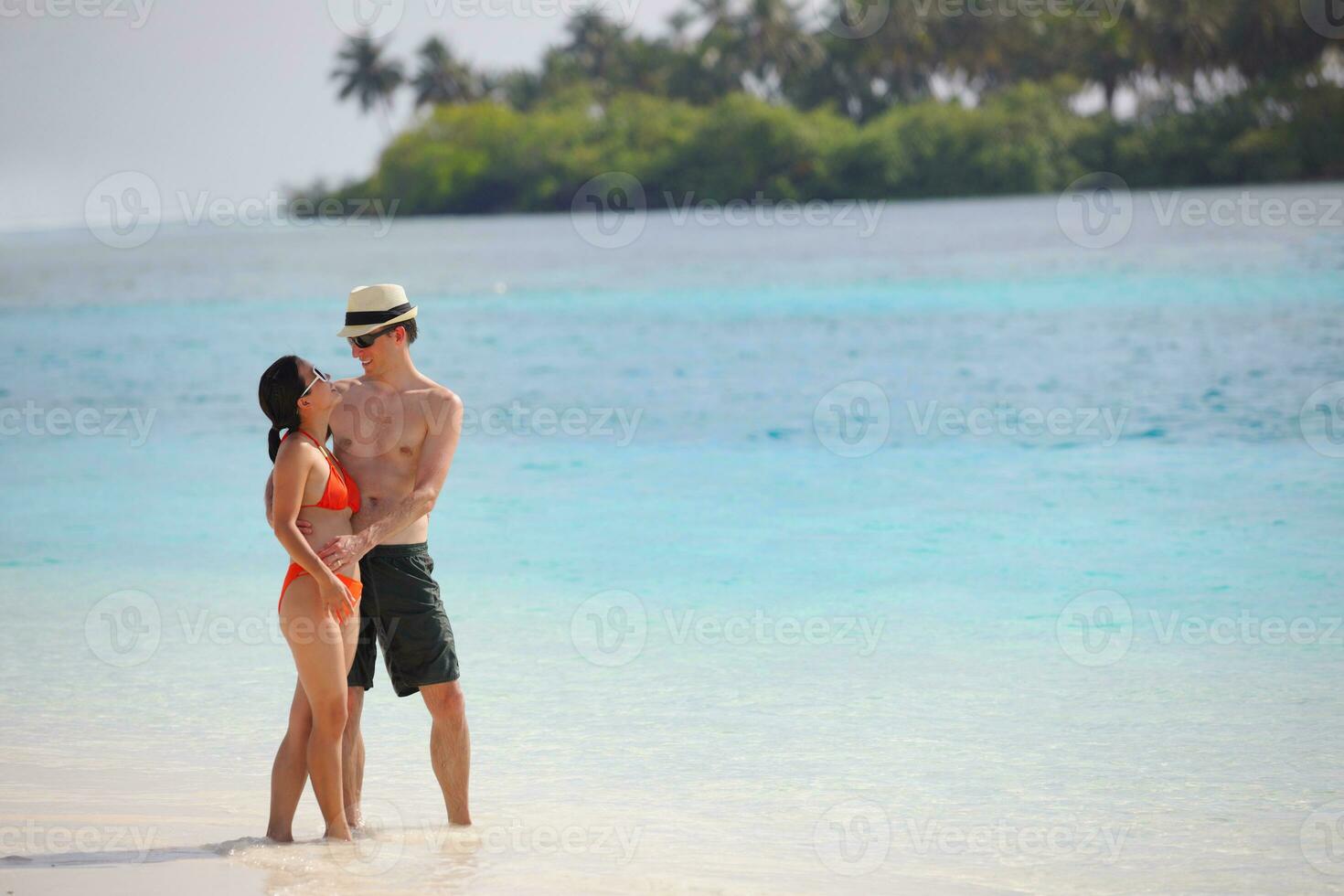happy young couple have fun on beach photo