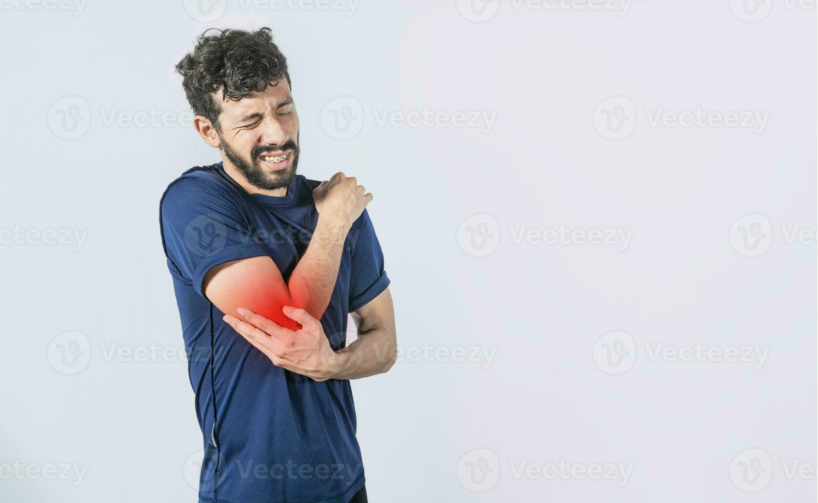 Concept of a man with rheumatism elbow pain, man massaging sore elbow, man with elbow cramp, Person with elbow pain photo