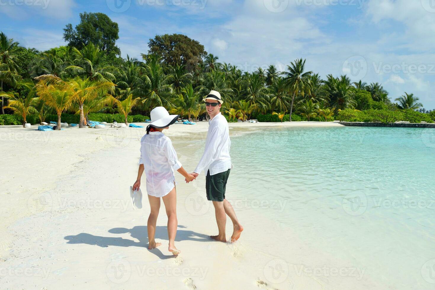 happy young couple have fun on beach photo