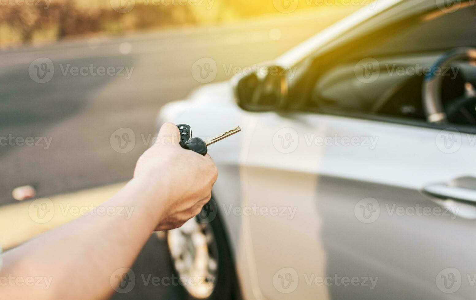 Close-up of driver outside car holding keys. Driver hands showing the car keys, Driver hands showing the keys outside the vehicle, Vehicle rental concept photo