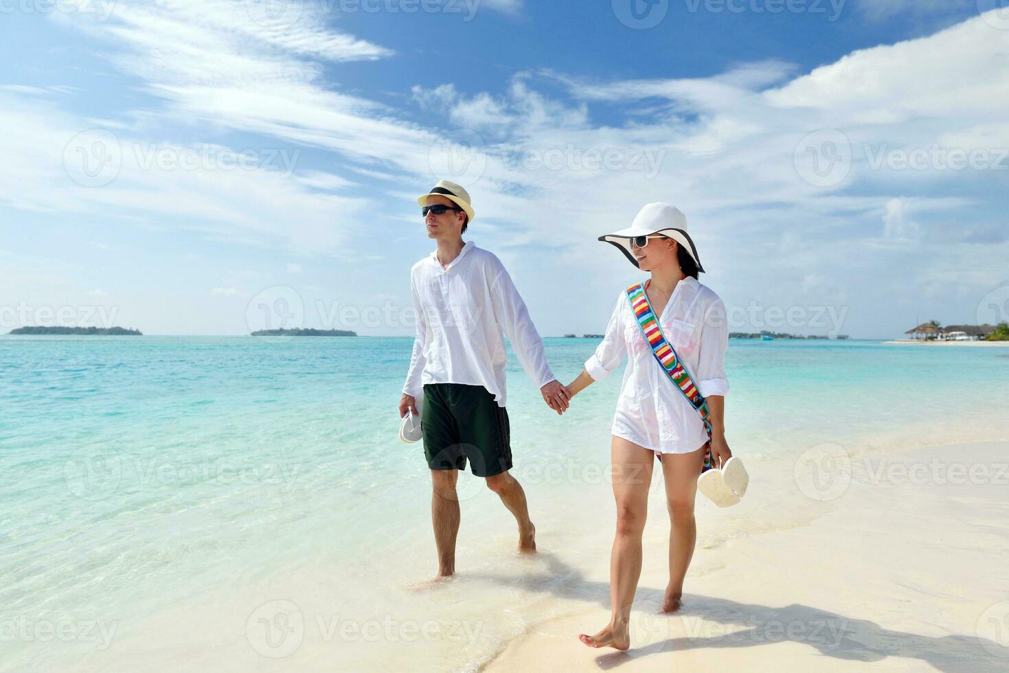 happy young couple have fun on beach photo