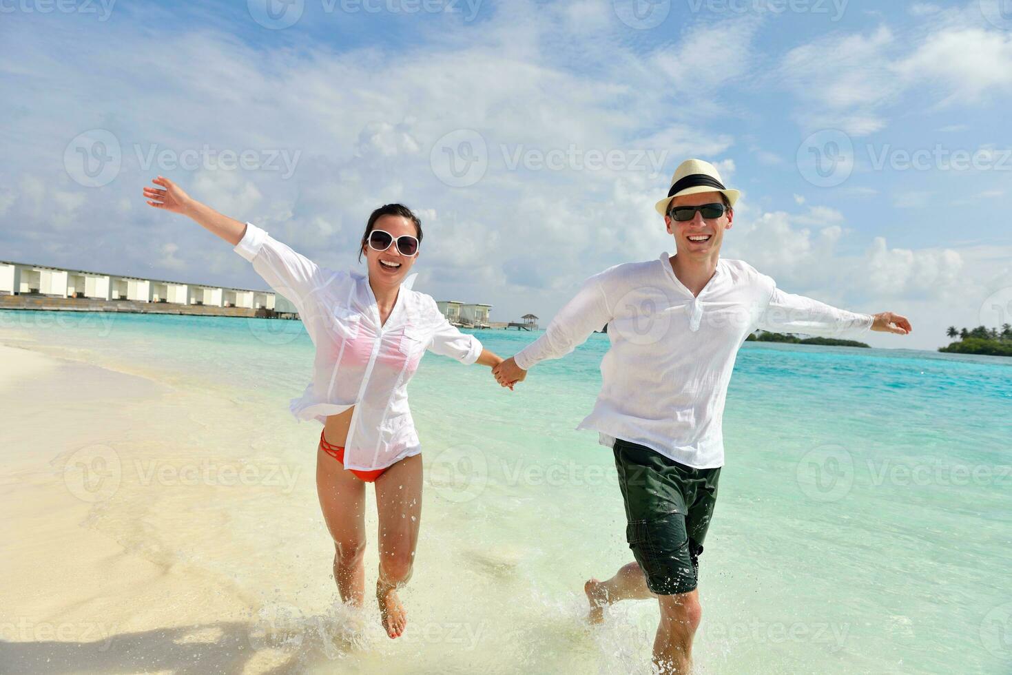 happy young couple have fun on beach photo