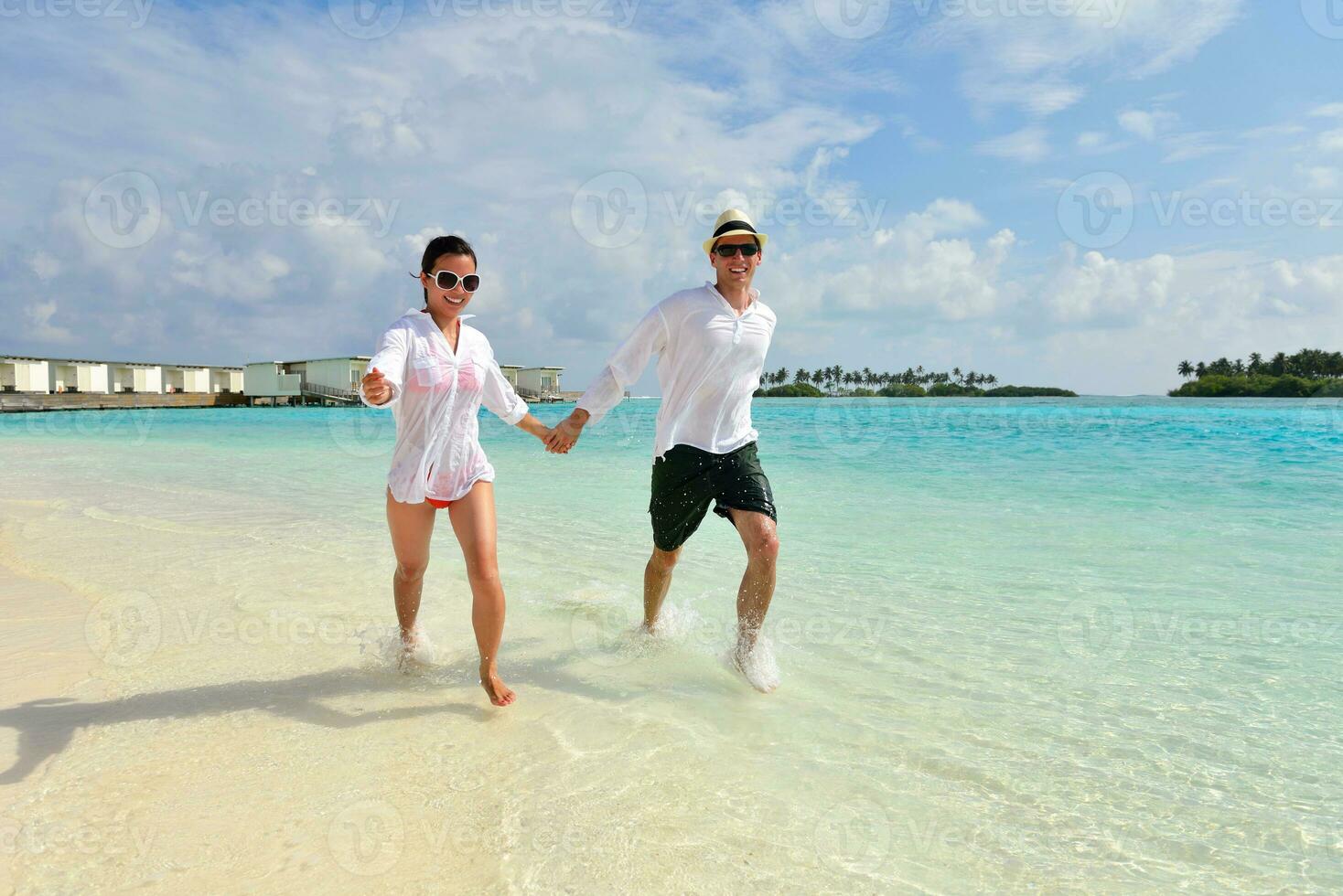 happy young couple have fun on beach photo