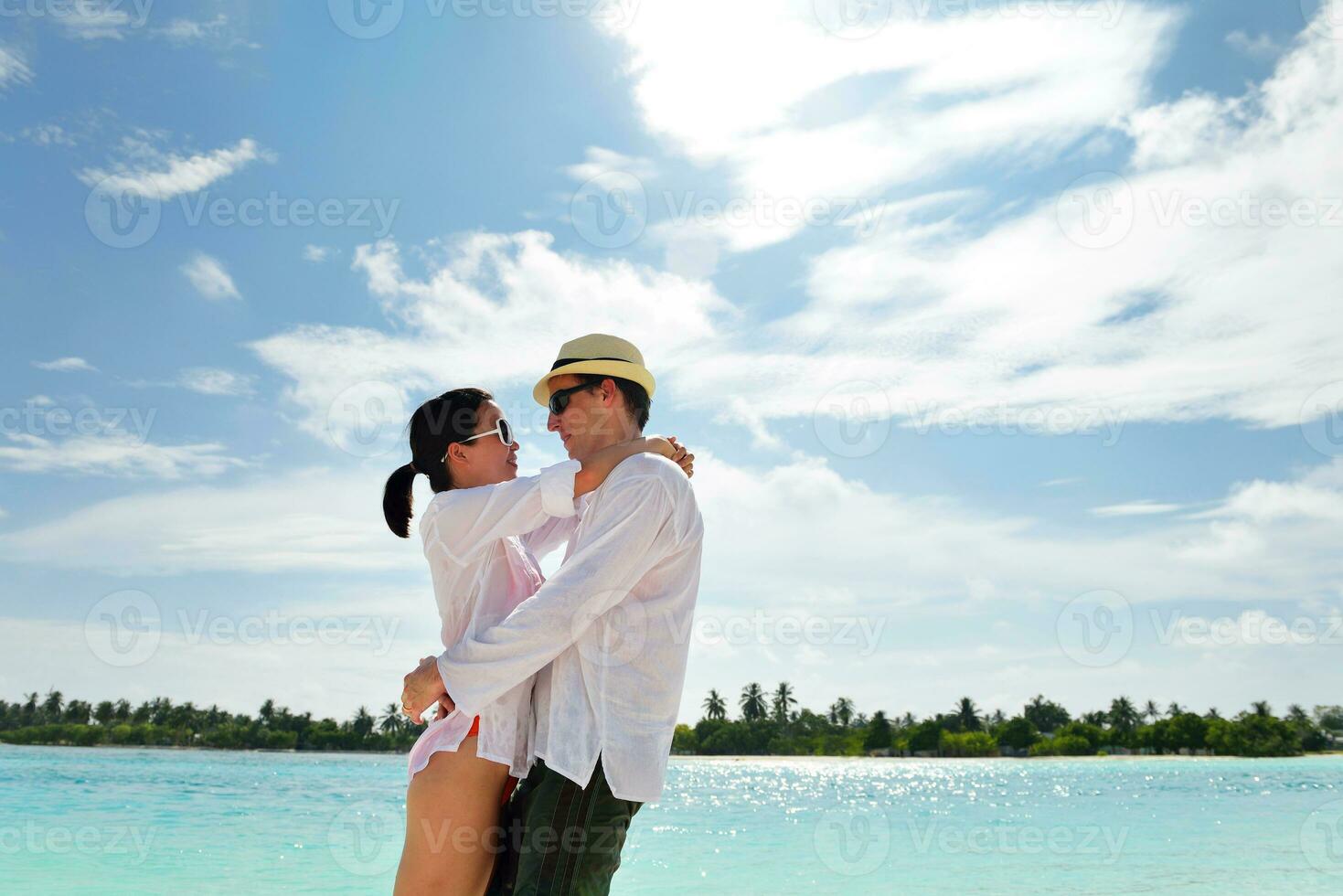 happy young couple have fun on beach photo