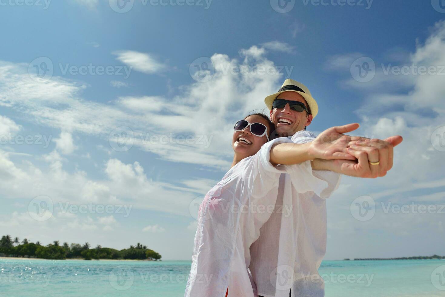 happy young couple have fun on beach photo