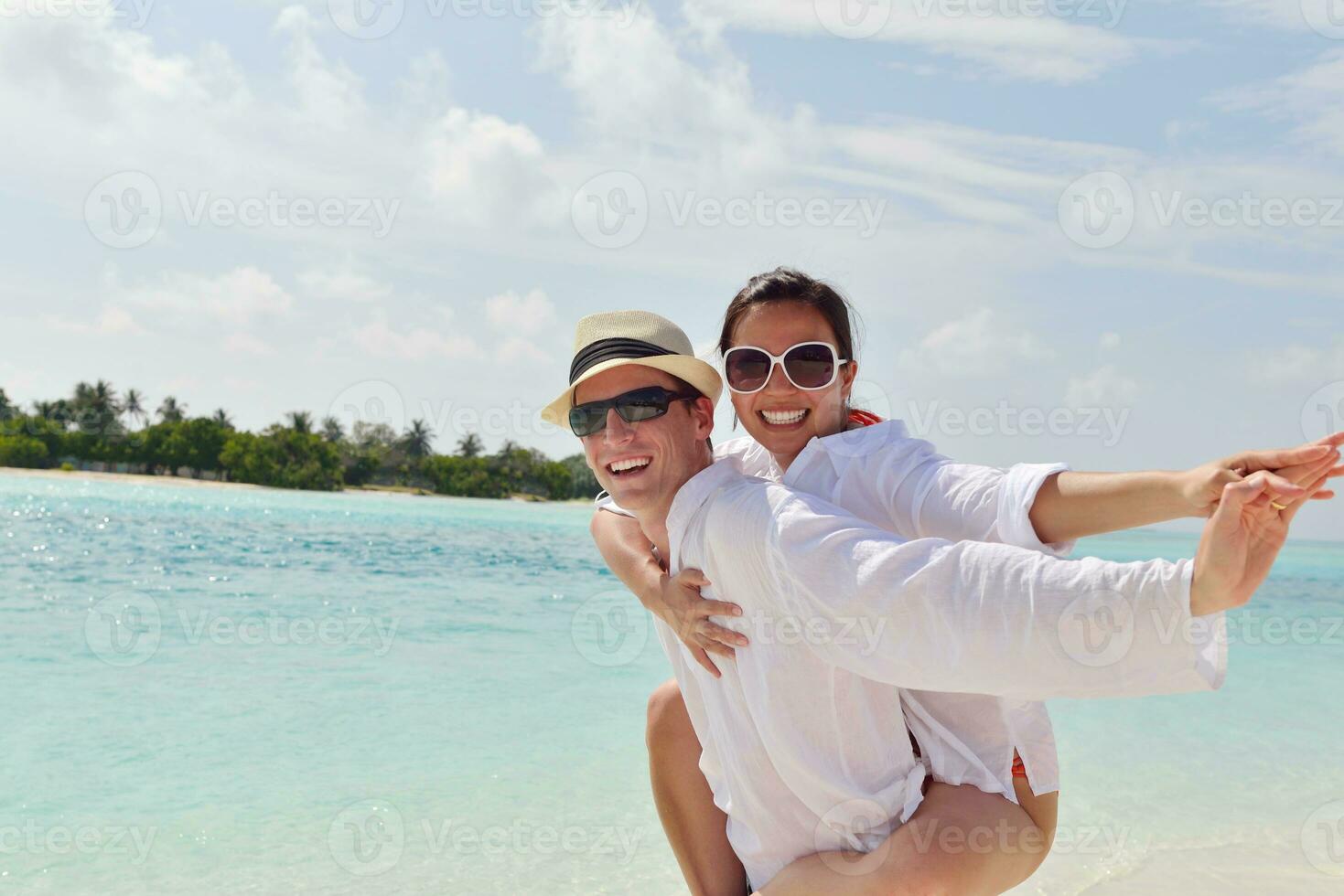 happy young couple have fun on beach photo