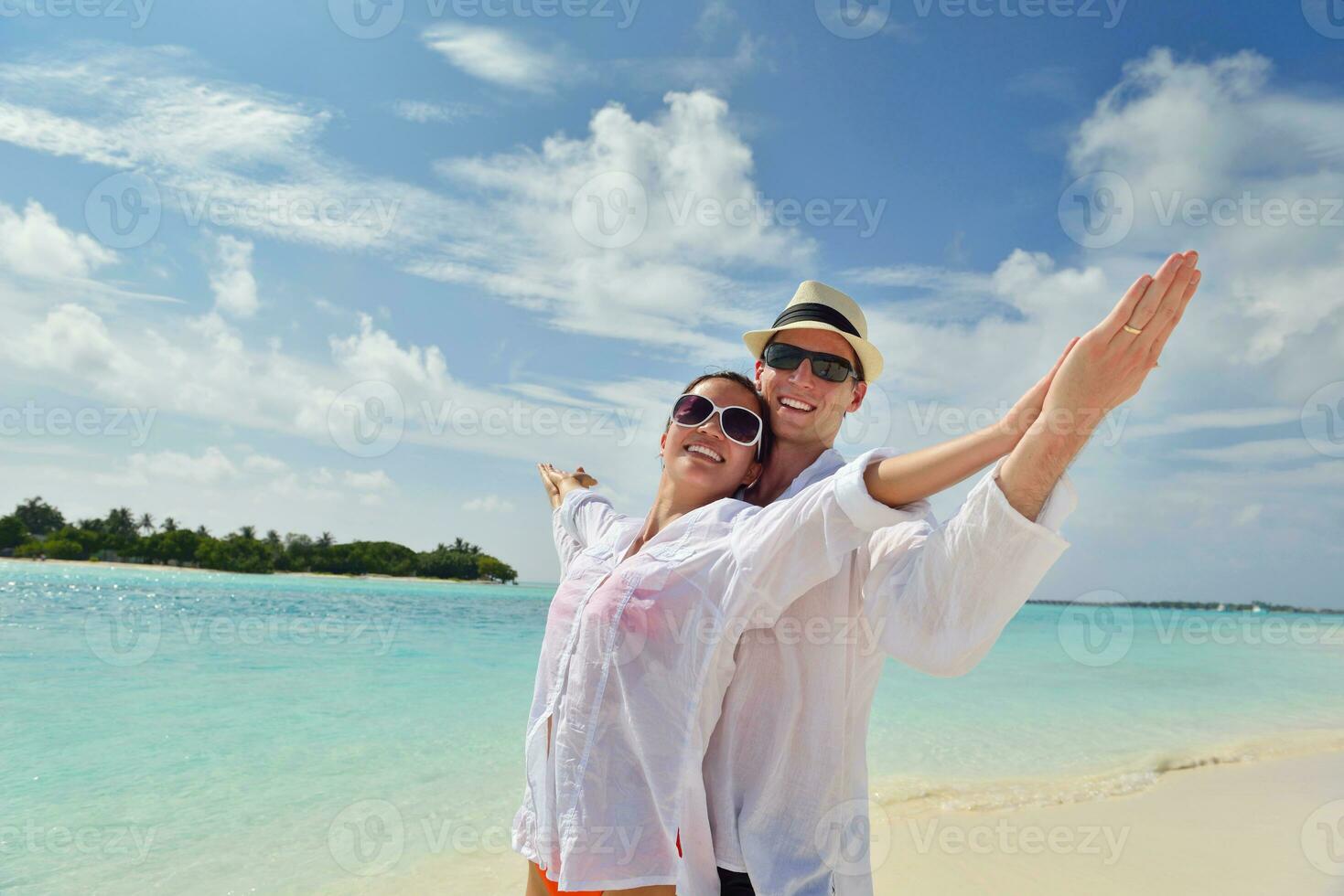 happy young couple have fun on beach photo