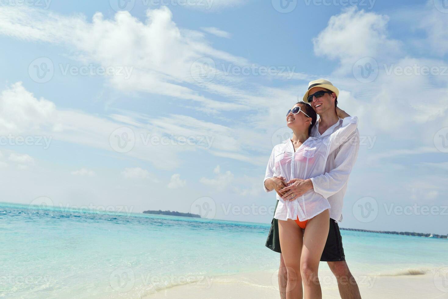 happy young couple have fun on beach photo
