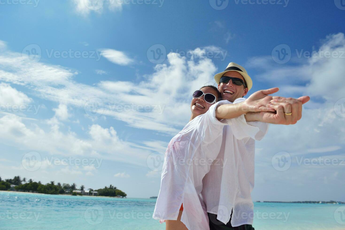 happy young couple have fun on beach photo