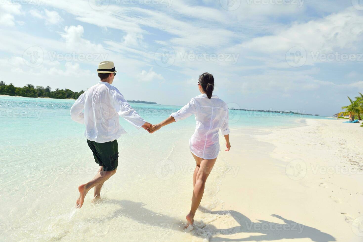 happy young couple have fun on beach photo