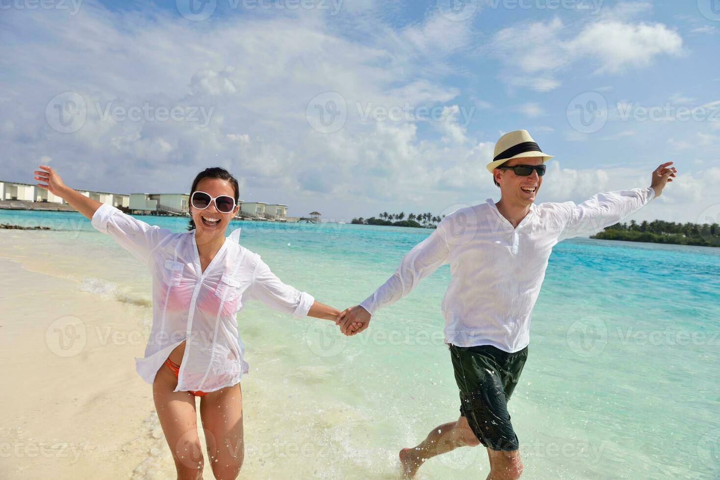 happy young couple have fun on beach photo