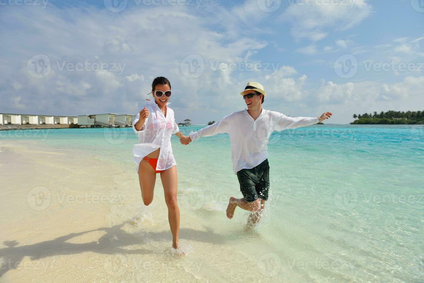 happy young couple have fun on beach photo