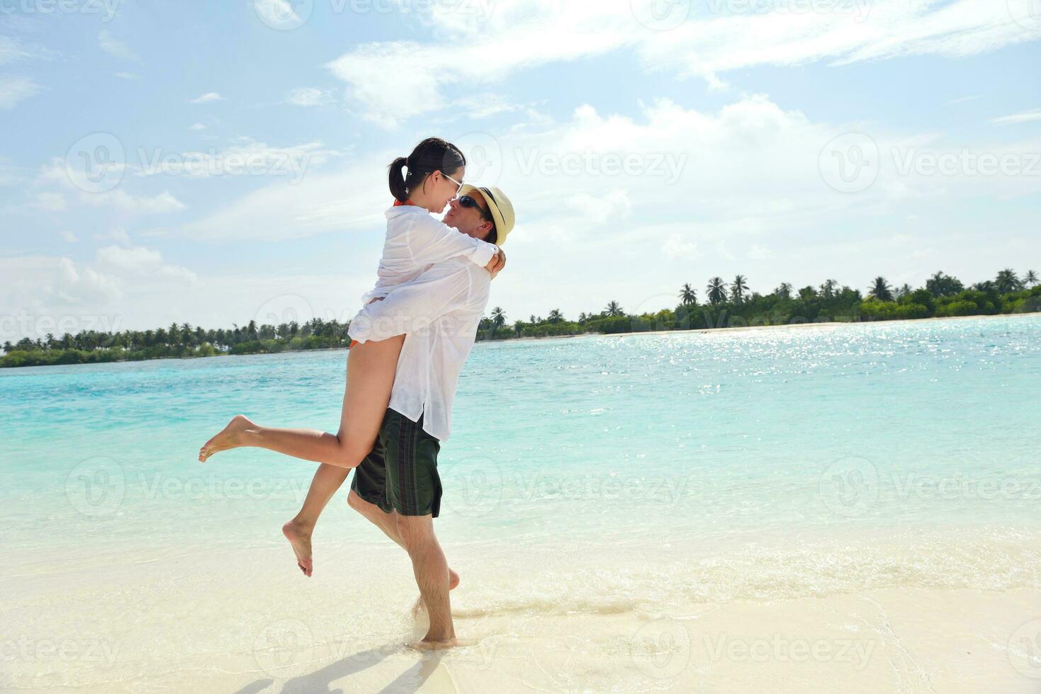 happy young couple have fun on beach photo