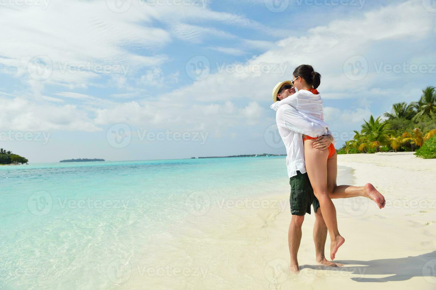 happy young couple have fun on beach photo