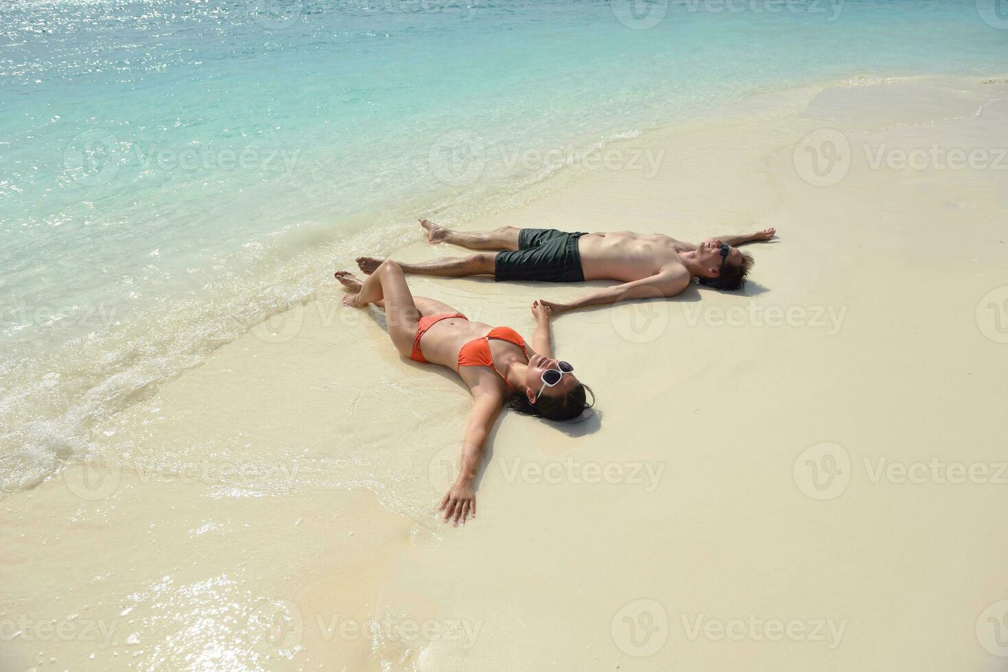 happy young couple have fun on beach photo