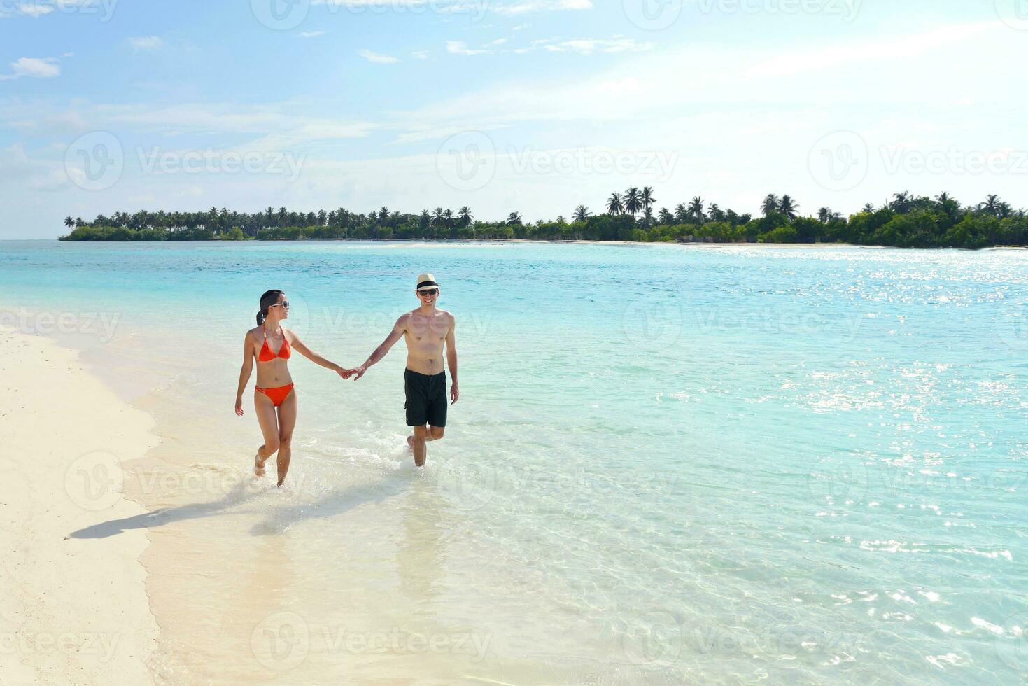 happy young couple have fun on beach photo