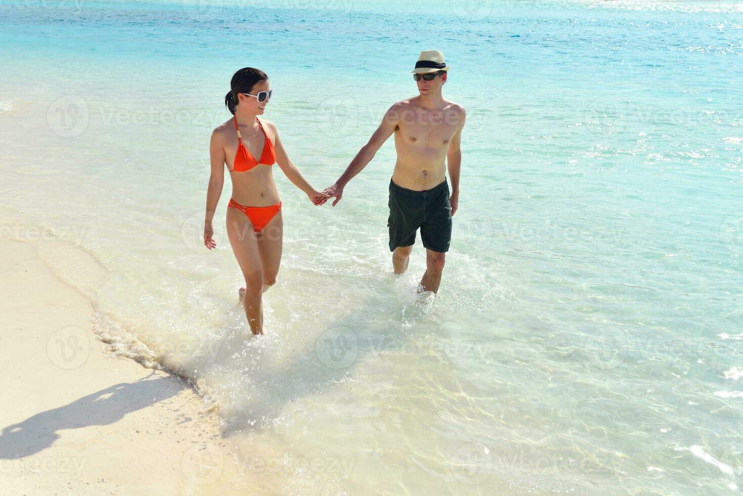 happy young couple have fun on beach photo