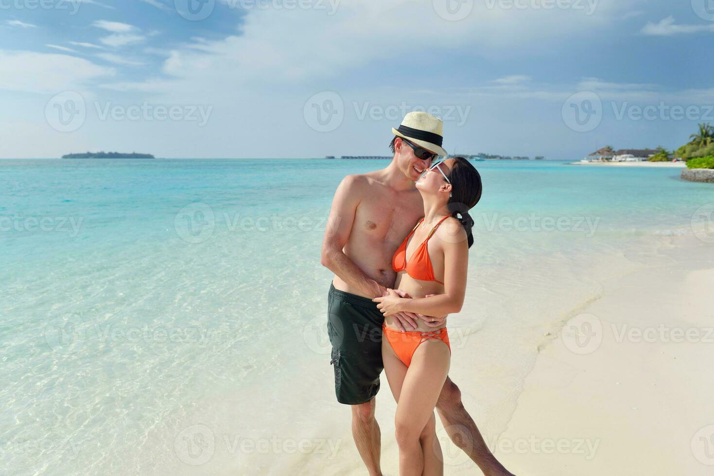 happy young couple have fun on beach photo