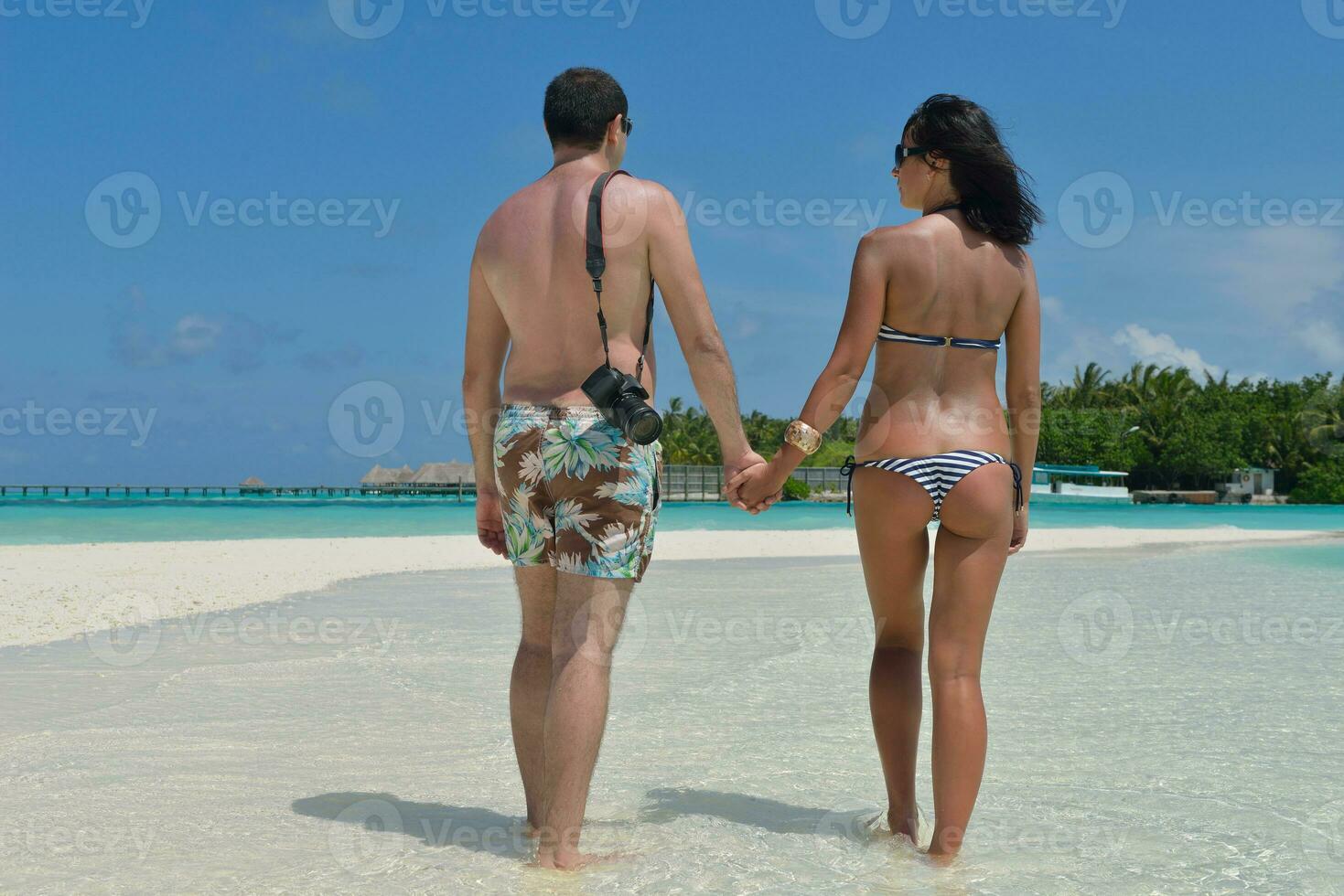 happy young couple have fun on beach photo