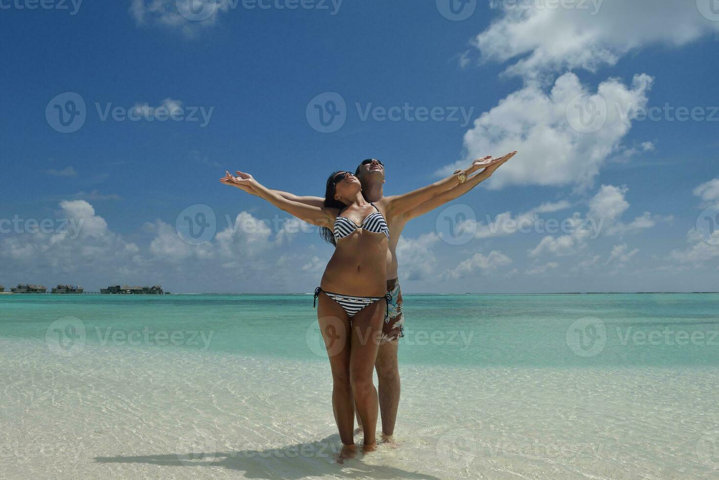 happy young couple have fun on beach photo