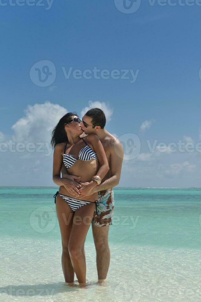 happy young couple have fun on beach photo