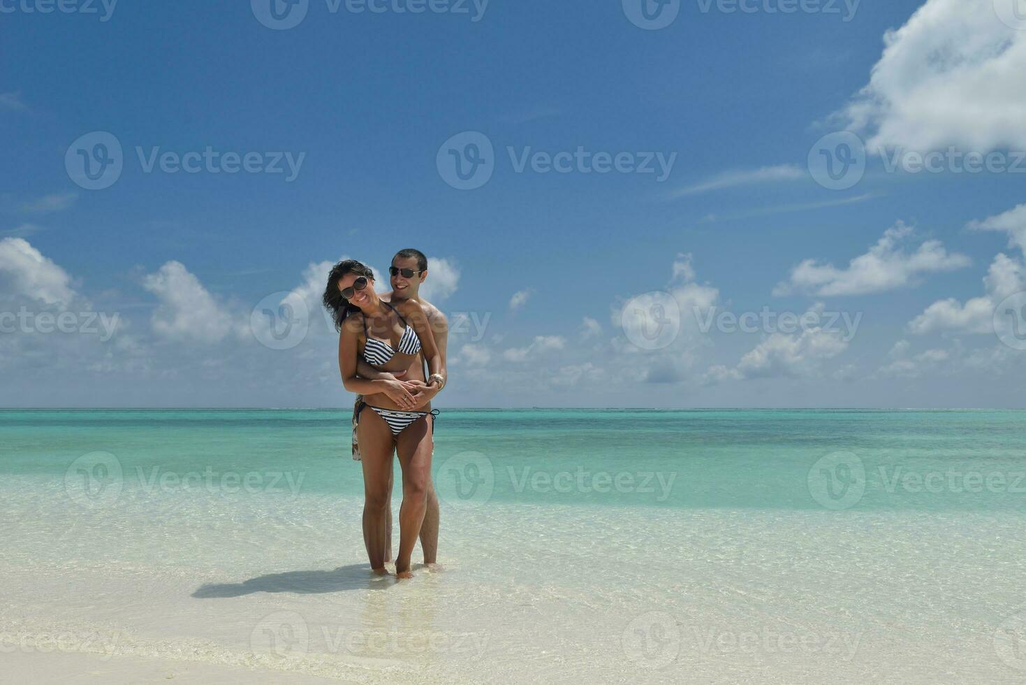 happy young couple have fun on beach photo