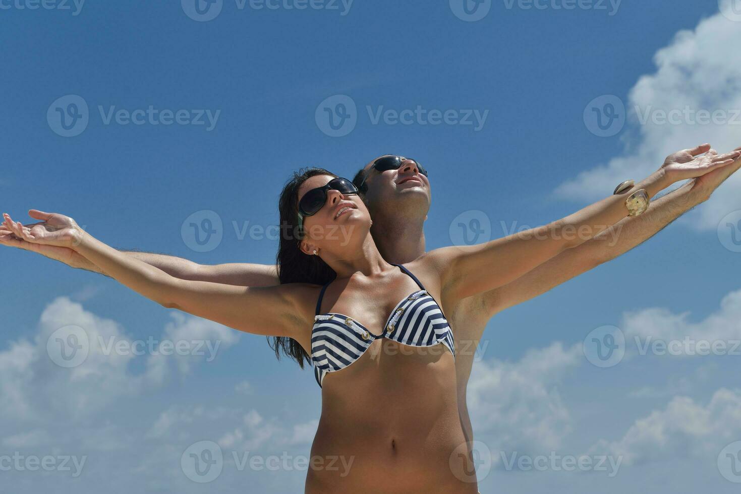 happy young couple have fun on beach photo