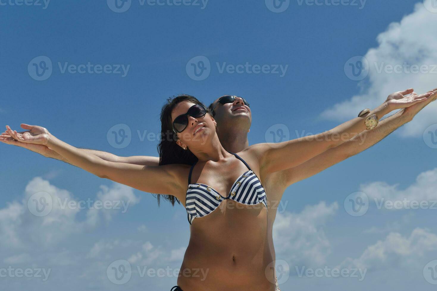 happy young couple have fun on beach photo