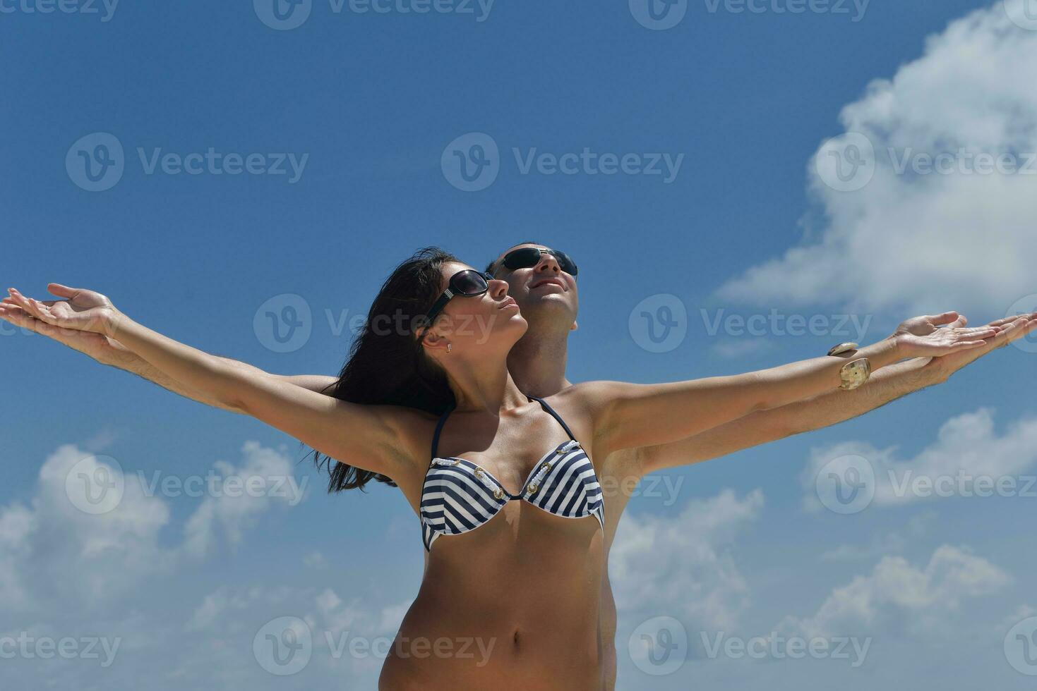 happy young couple have fun on beach photo