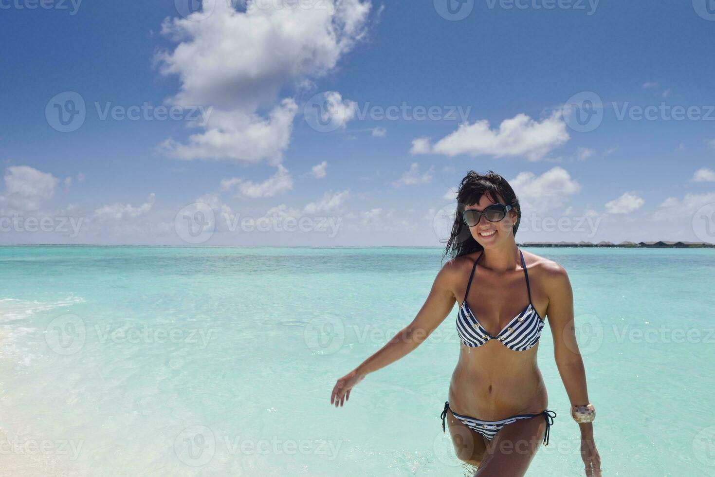 beautiful young woman  on beach have fun and relax photo
