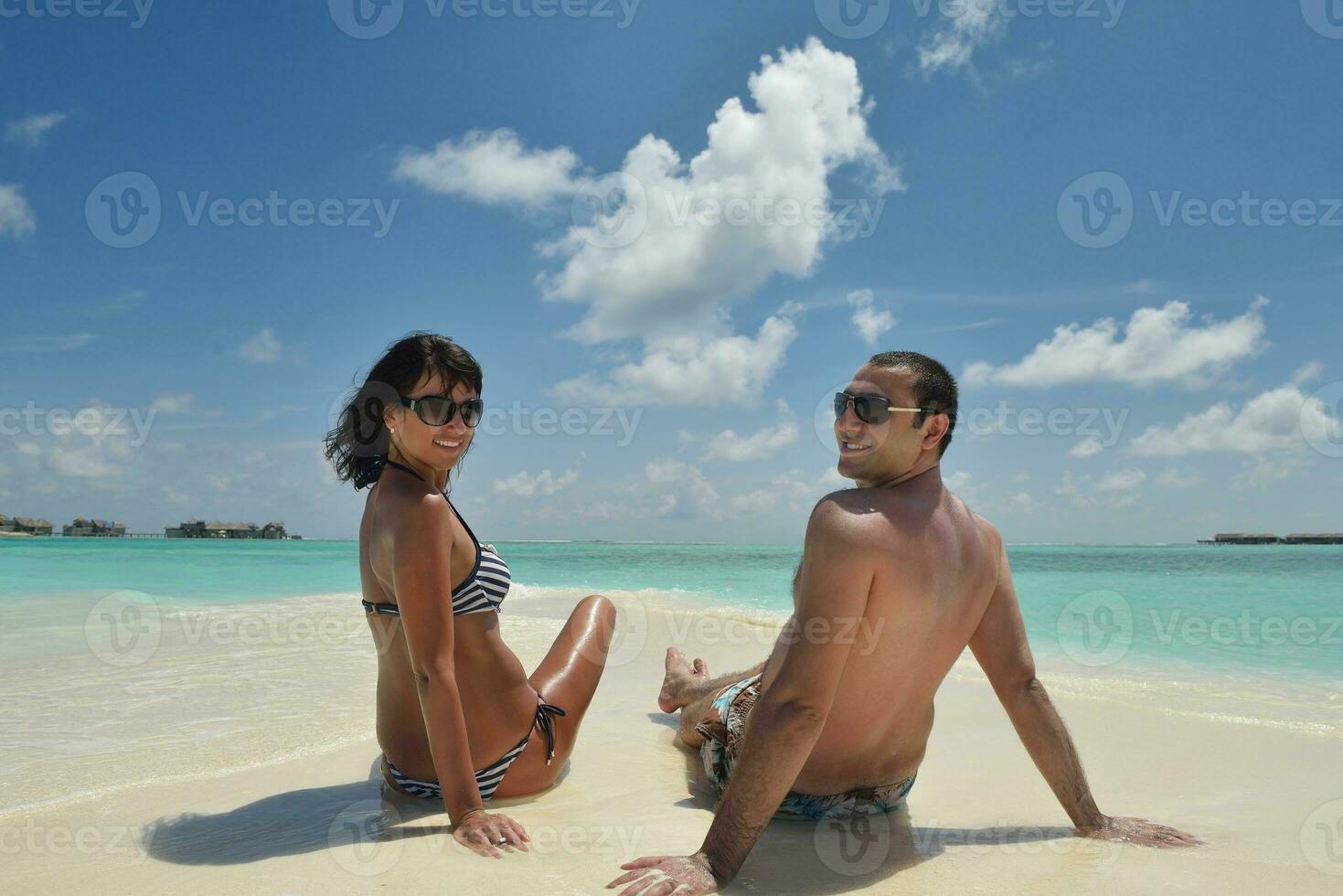 happy young couple have fun on beach photo