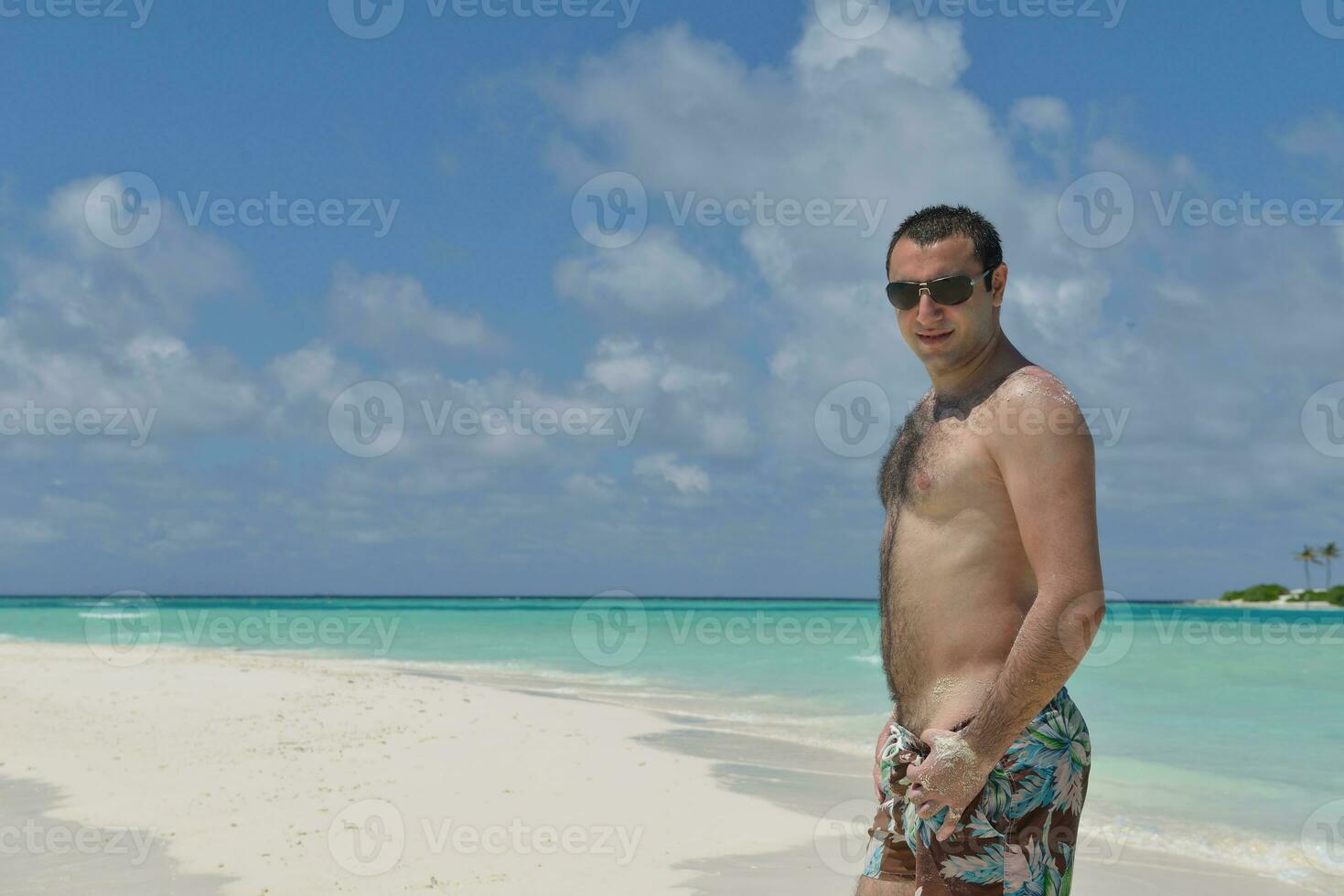 young man have fun and relax on beach photo