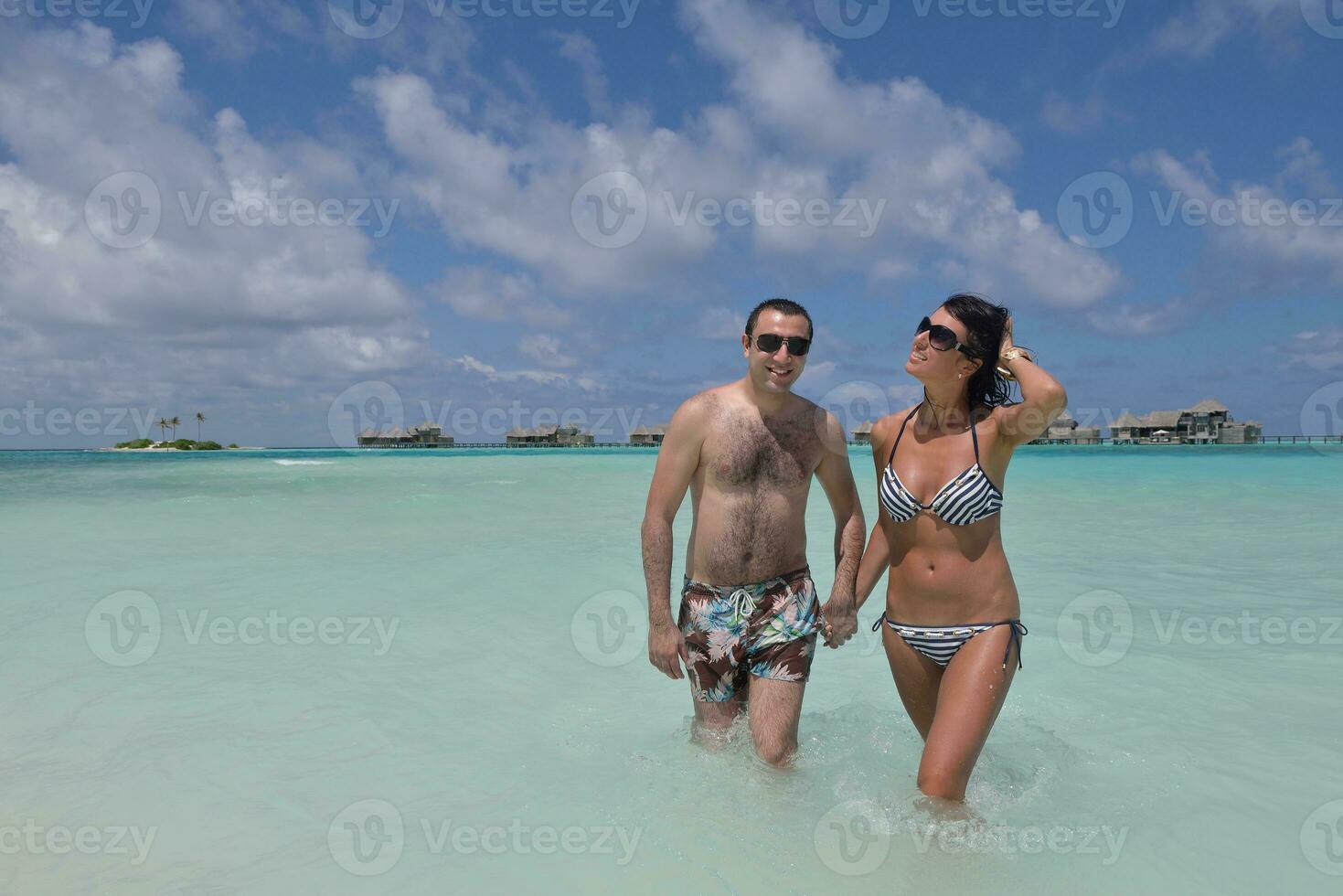 happy young couple have fun on beach photo