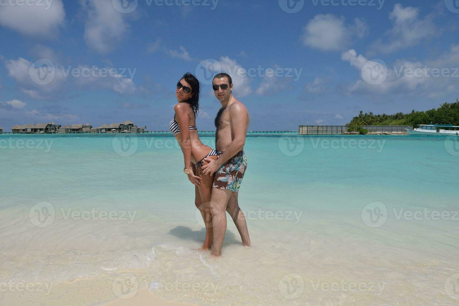 happy young couple have fun on beach photo