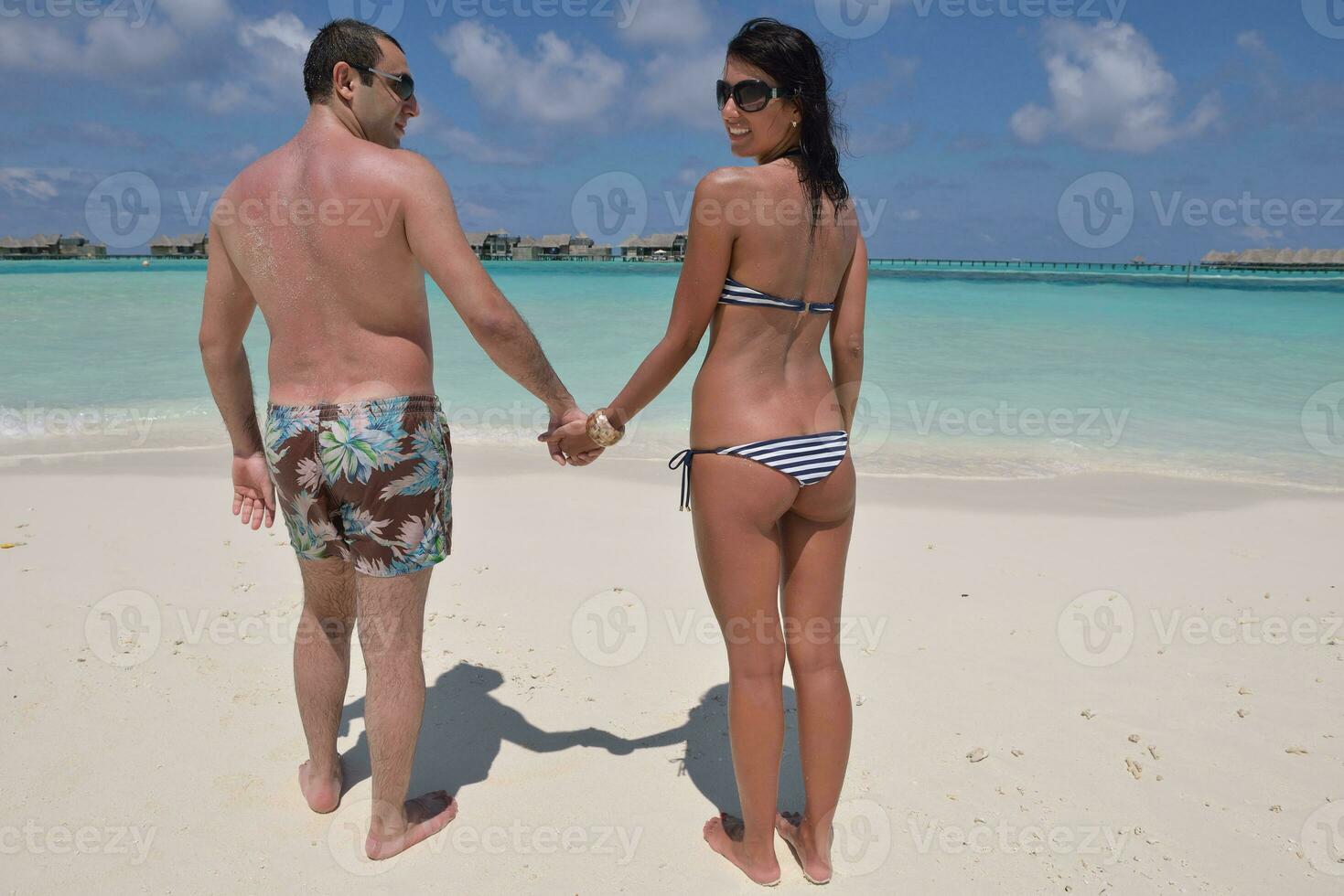 happy young couple have fun on beach photo