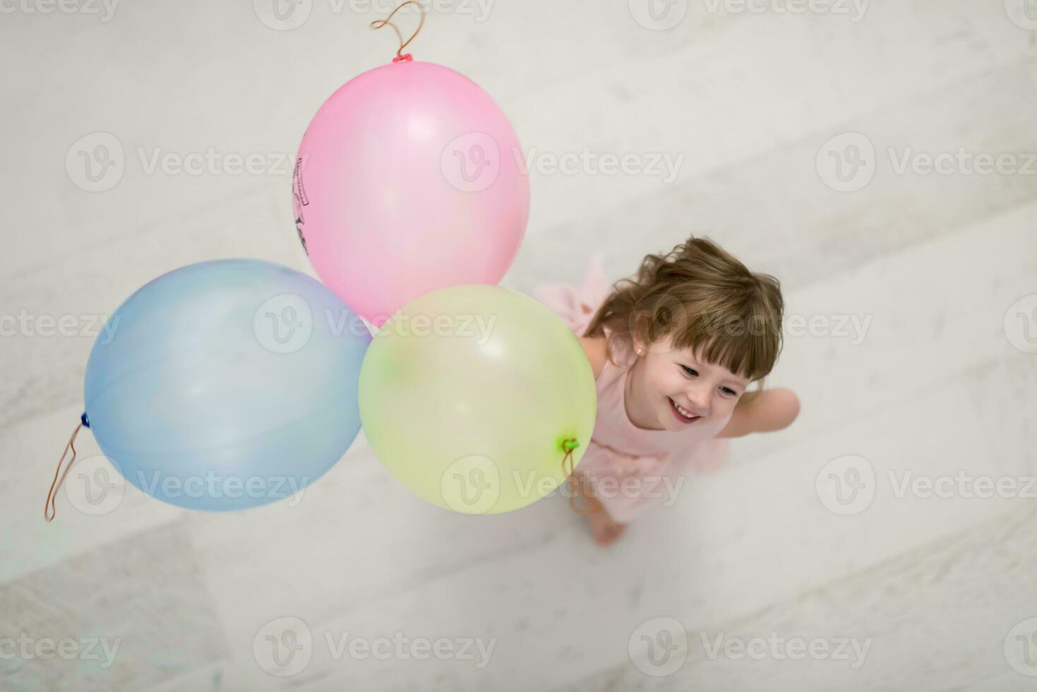 cute little girl playing with balloons photo