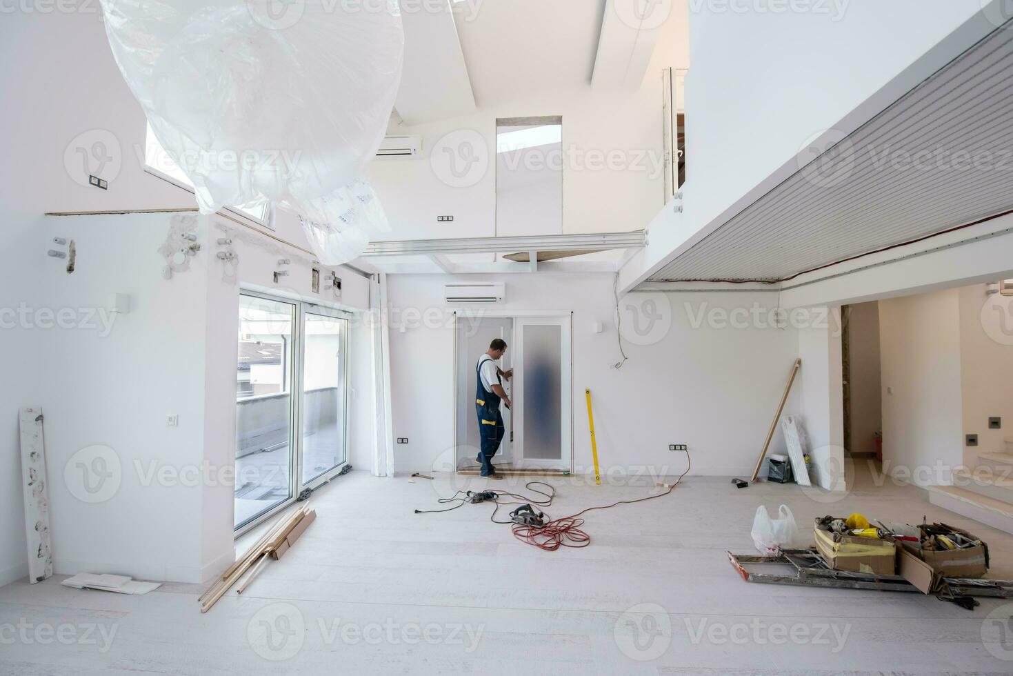 carpenters installing glass door with a wooden frame photo