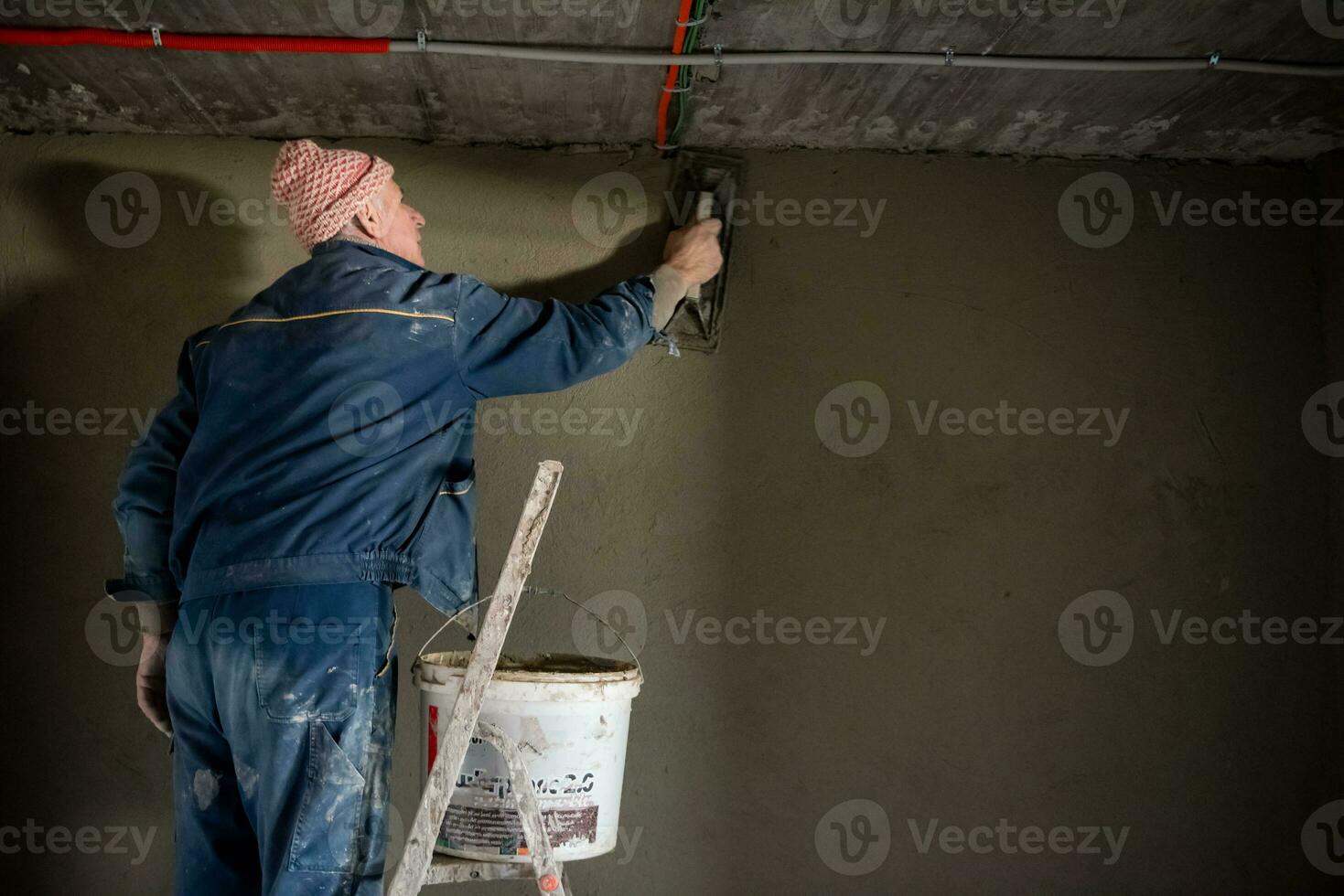 Worker plastering the wall by concrete photo